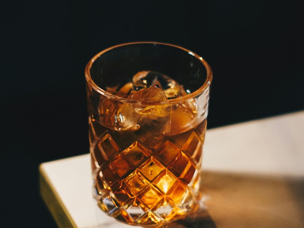 A well drink on the bar.